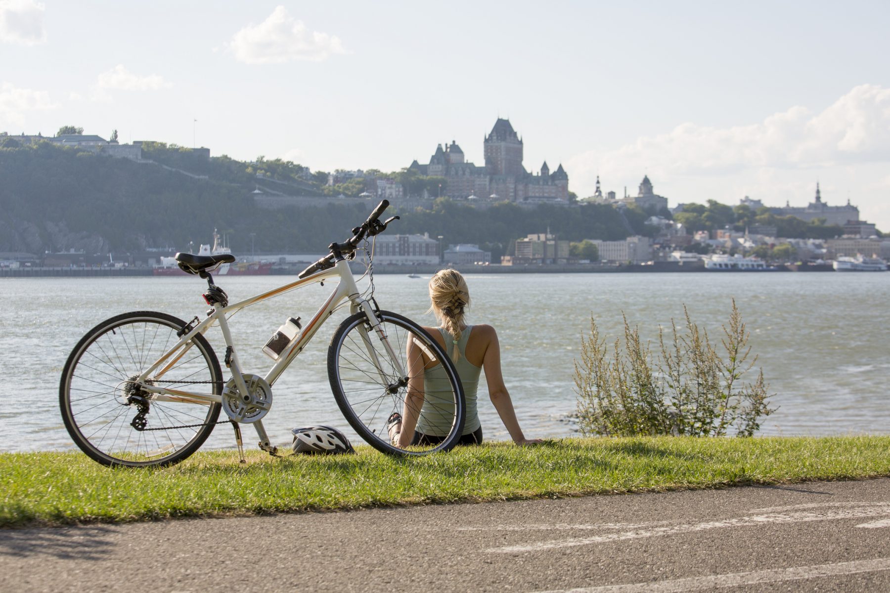Young Woman with Bike outside with quebec view